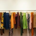 A vibrant display of assorted garments on a rack in a fashion store.